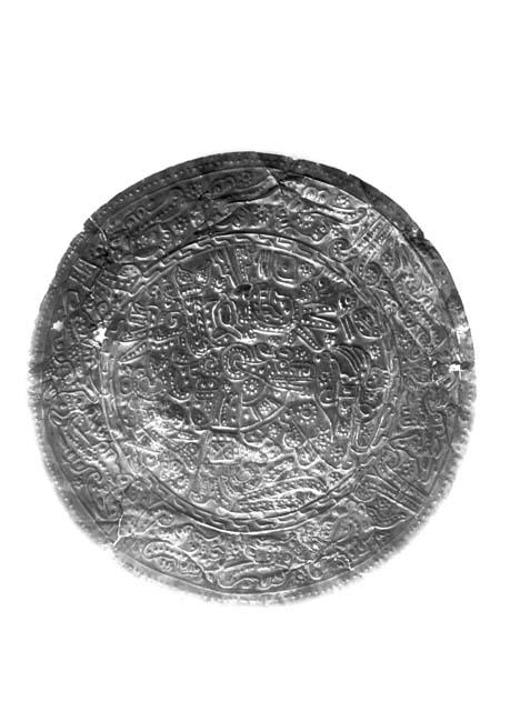 Metal disc ornamented with repousse design