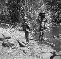 Children who come daily to fill gourds at the stream
