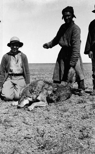 Eleanor Lattimore kneeling by dead wolf