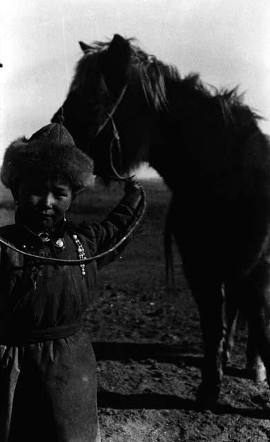 Khongkor holding reins of pony