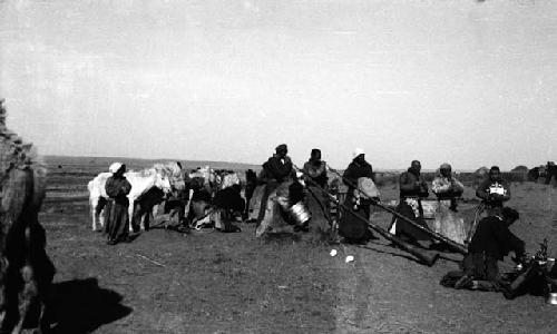 Two men playing long trumpets at loading of Chingghis' tent