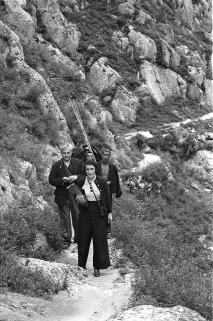 Philip and Agnes Jaffe and two other men on rocky trail on hillside