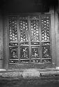 Ornate, carved and painted panel in stone wall