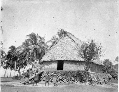 People standing in front of house in Narvi Village