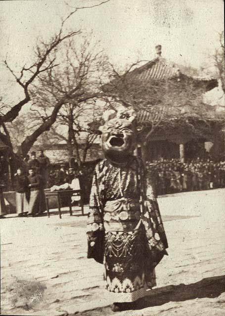 Chinese person in costume with mask