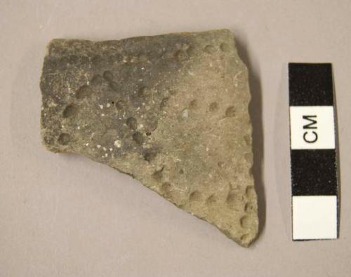 Ceramic rim sherd, design of linear punctations