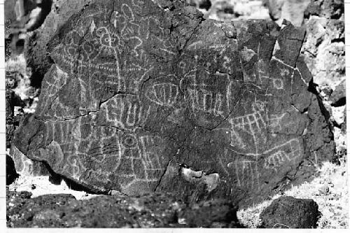 Photo of Petroglyphs - many designs, face with eyes