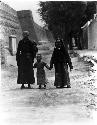 Image of Mongol family walking by walls