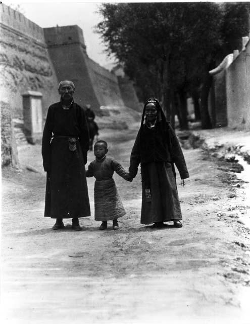 Image of Mongol family walking by walls