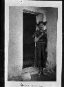 Hopi woman of Oraibi standing in a doorway