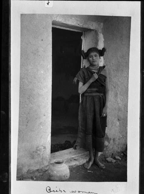 Hopi woman of Oraibi standing in a doorway