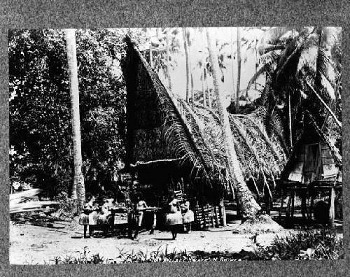 People standing in front of house