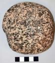 Possible smoothing stone; nearly discoidal cobble; one flake removed from periph