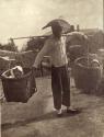 Chinese man carrying children in baskets