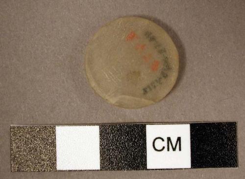 Disc. 2 flat, smooth surfaces, flat & fairly thick rim. translucent. gypsum