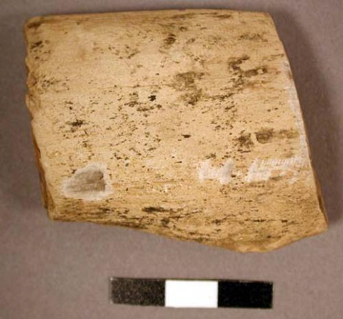 Flaked lithic. rectangular with ovoid transverse cross section. exhibits flaking