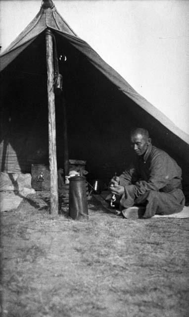 Arash sitting at doorway of an open tent