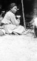 Khalkha girl drinking tea in front of open tent