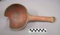 Black on red pottery ladle