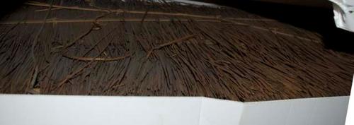 Model of hut, portion of thatched roof, twisted fiber rope,reed supports