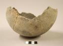 Ceramic, partial vessel, rounded base and body, gray, mended