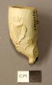 Clay pipe bowl with harp and floral design.
