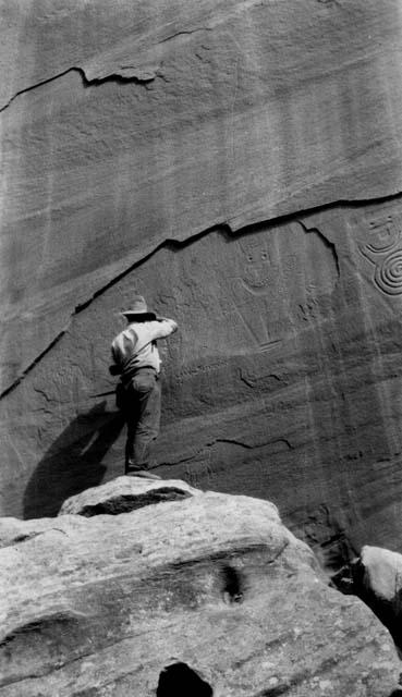 Pictograph group on the right bank, Oyler's ranch, Fruita; worker in foreground