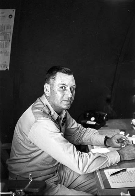 Soldier sitting on chair writing on paper