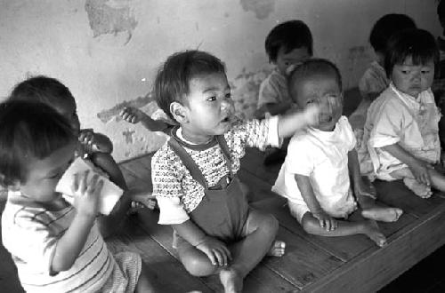 Potrait of babies sitting side by side together