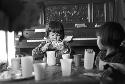 Girl sitting at table playing with card