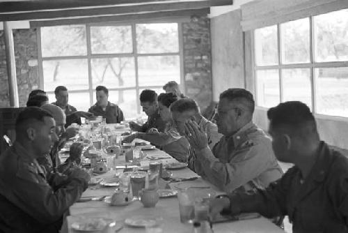 Portrait of men at large dinner table conversating before meal