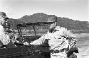 Soldier standing by jeep waiting