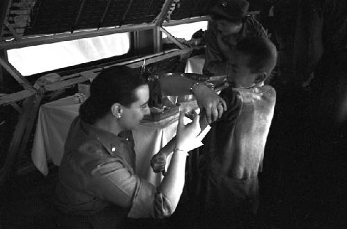 Boy recieving shot in the by nurse