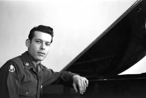 Portrait of officer with arm rested on piano