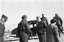 Portrait of soldiers walking on road by car