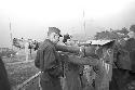 Soldiers standing by machine gun