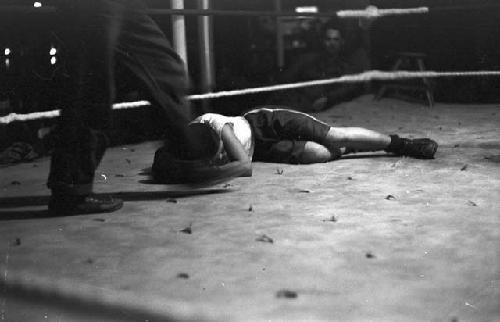 Boxer laid out on canvas in ring 2