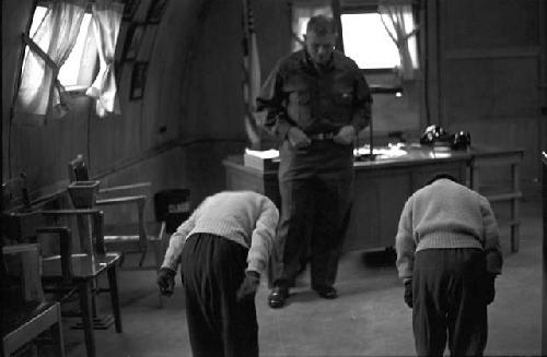 Portrait of girls bowing before the genral