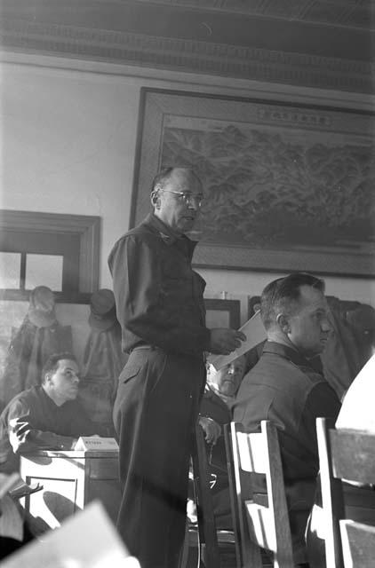 Soldier standing at table during meeting