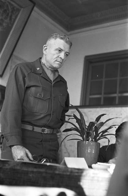 Portrait of general at head of table speaking