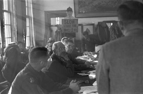 Portrait of Man standing at head of table