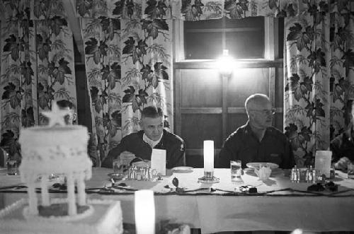 Portrait of general and soldiers eating dinner