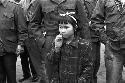 Little girl standing in front soldiers
