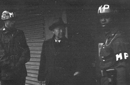 Soldiers standing outside with man in front of building