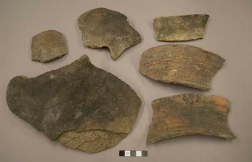 Sherds of large jar, upper part corrugated.