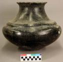 Large black pottery olla. Ridge around neck rim.