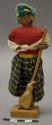 Doll, woman with broom, affixed to stand