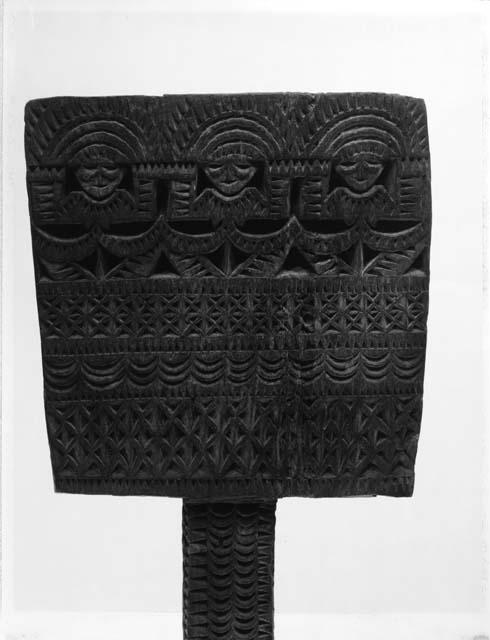 Head of carved wooden paddle