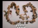 Necklace--animal claws, beads, thimbles & fragments of hoof strung on thong