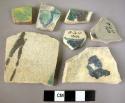 7 painted potsherds (blue, green, brown, yellow)